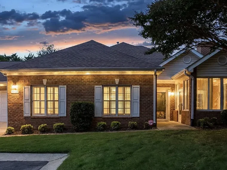 Exterior of the brick ranch-style condo at 10925 Oakside Court in Charlotte, NC, at dusk.